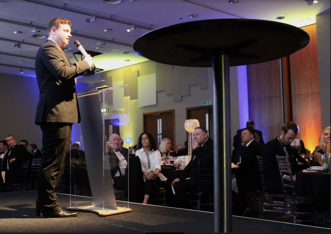 Bryan Mills speaking on stage
